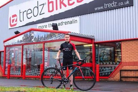 Deri shows off his bike outside the Tredz Swansea shop